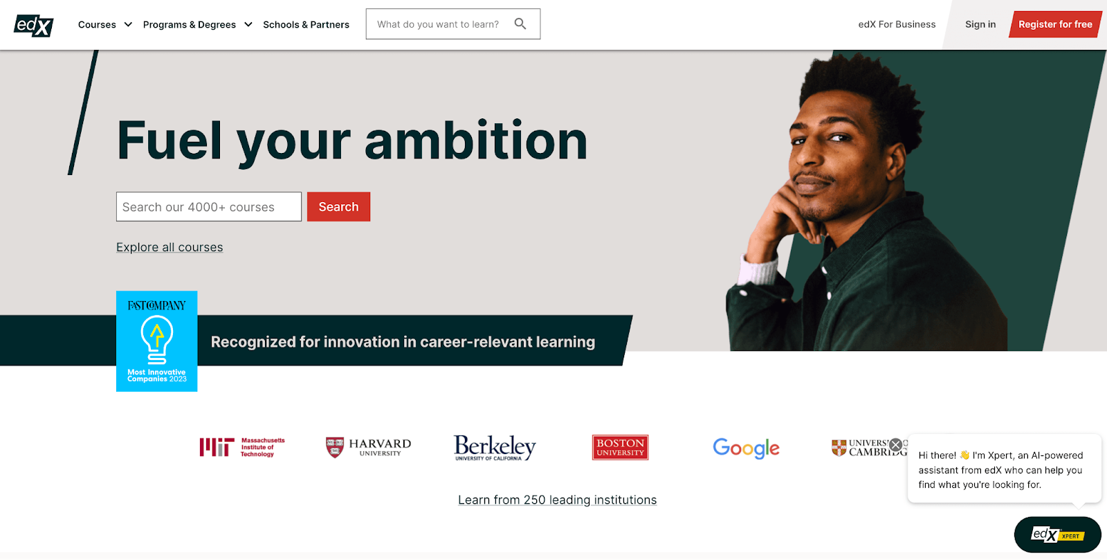 edX's homepage screenshot with text "Fuel your ambition and a black man with green shirt on the background"
