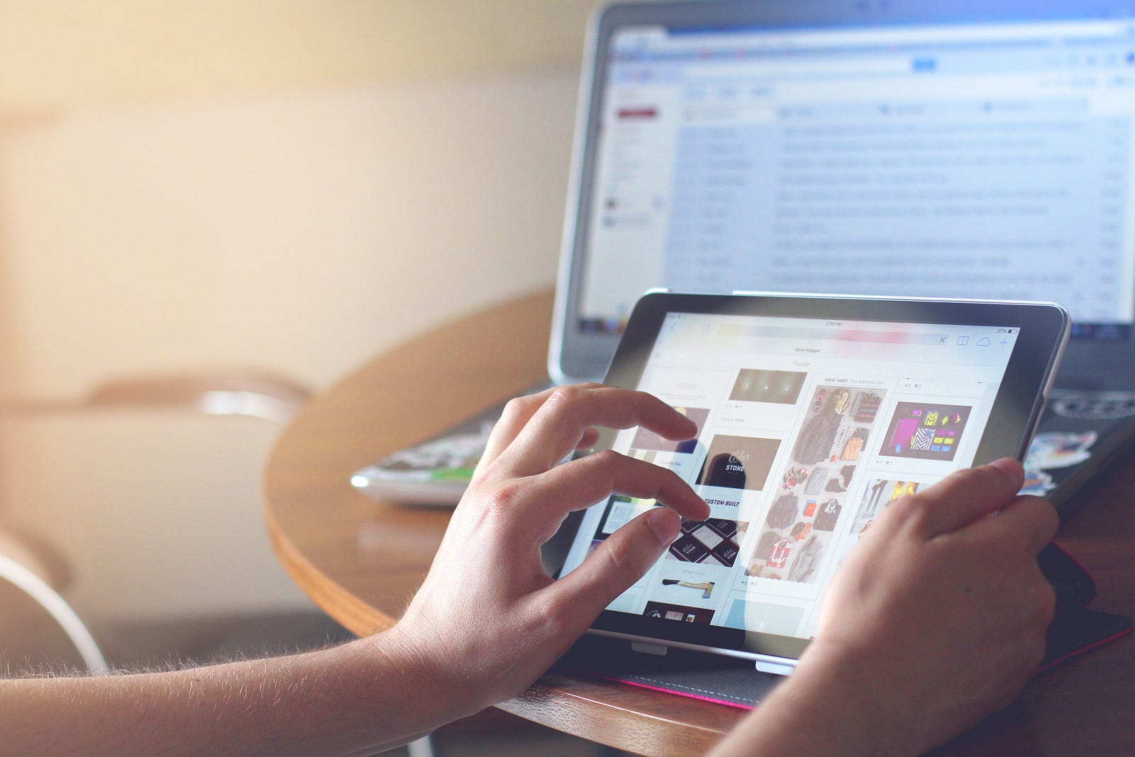 A person’s hand navigating on the screen of an ipad