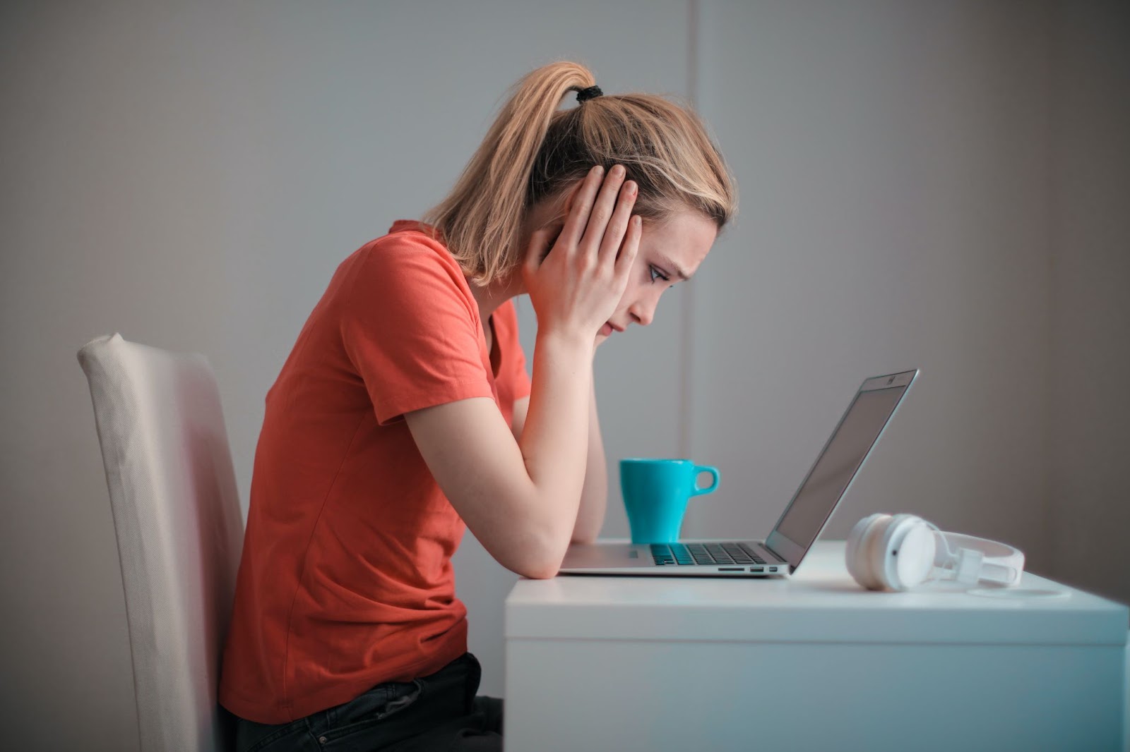 A person with a dilemma looking at a laptop screen