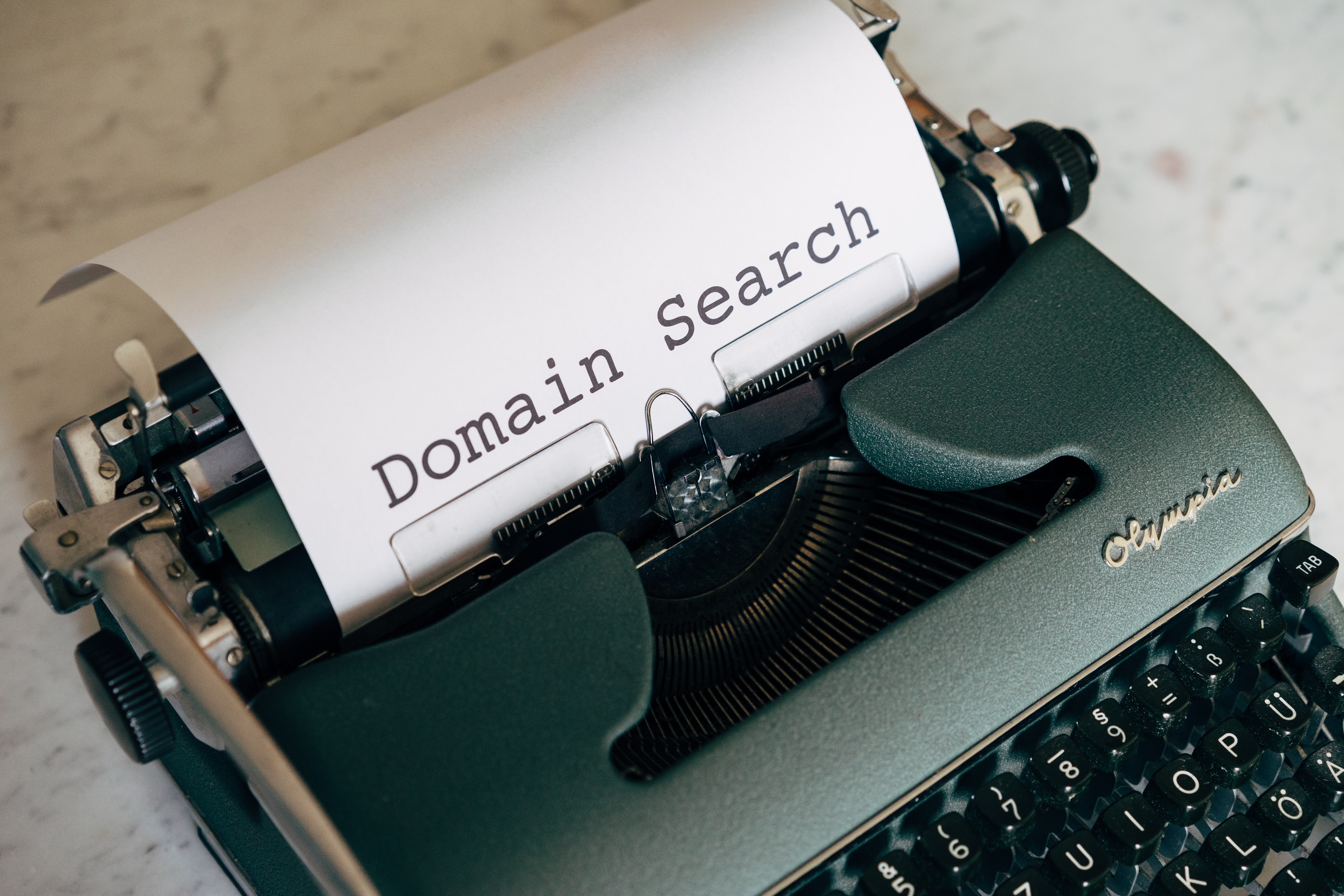A picture with "Domain search" written with a dactylograph