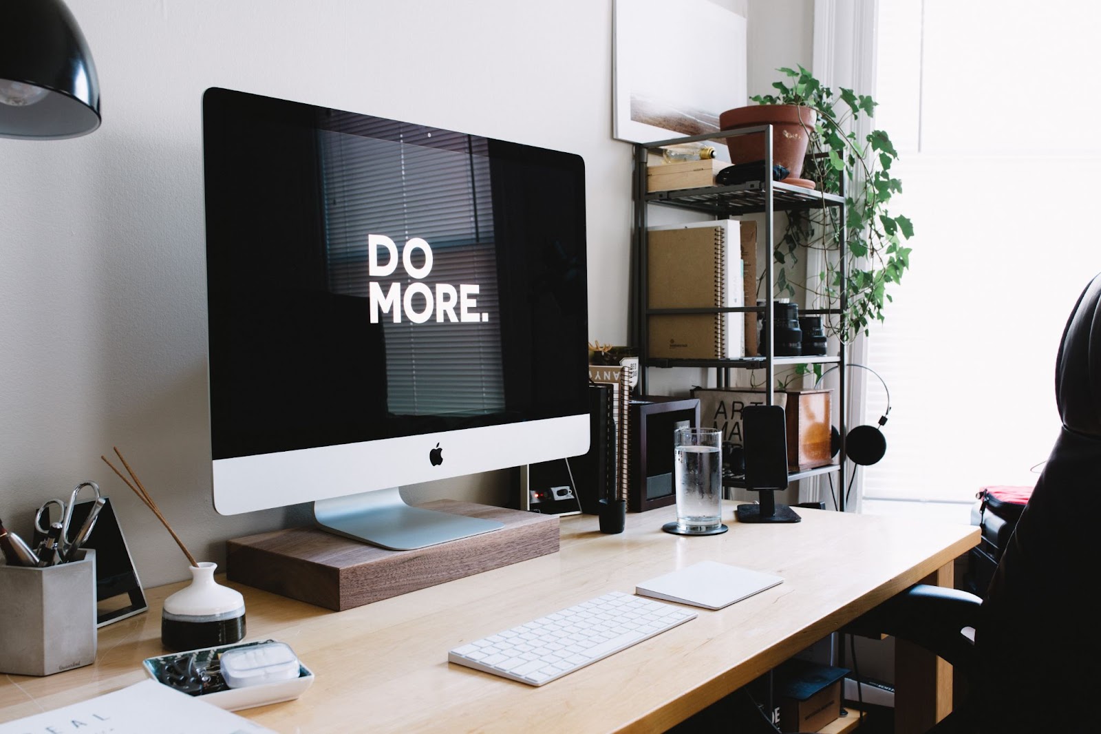 A mac computer screen showing a message in capital letters saying "DO MORE"